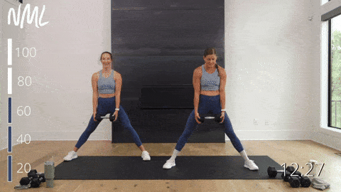 two women performing a lateral squat and bicep curl as part of a full body workout at home