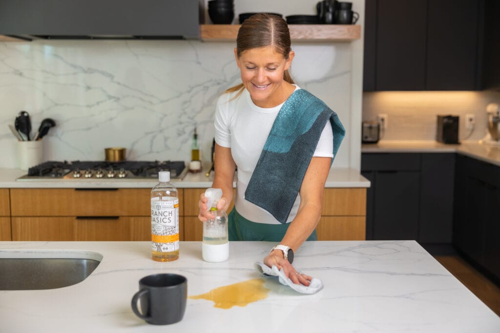 Women during her kitchen essentials, branch basics and geometry towels to clean a mess in the kitchen. 