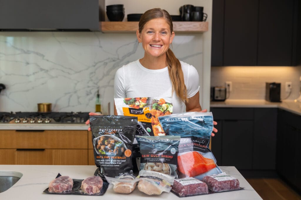 Women in her kitchen ready to meal prep with all the butcherbox products. Kitchen Essentials. 