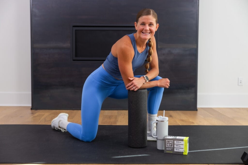 Women with a foam roller, water bottle and LMNT electrolytes | muscle recovery supplements | muscle recovery supplement
