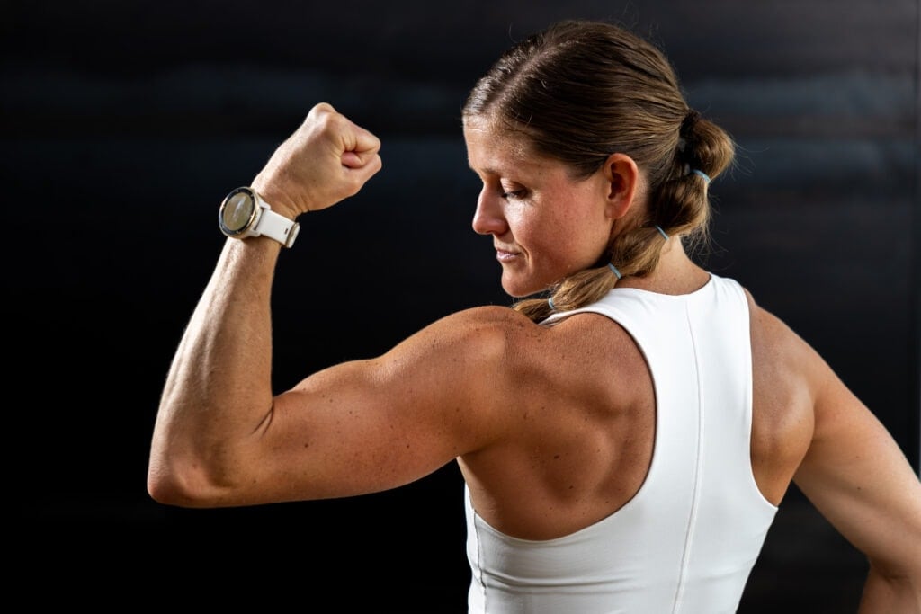 Women flexing left arm from behind