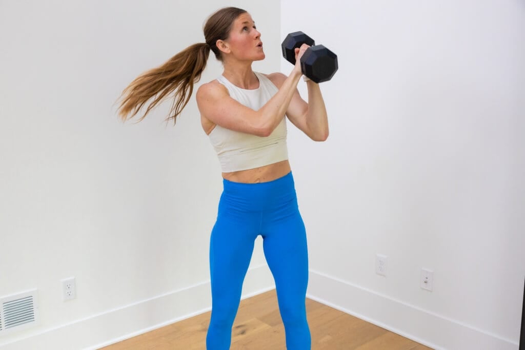 Woman performing a dumbbell woodchop