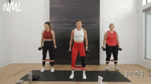 three women performing hammer curls and shoulder presses as part of circuit workout