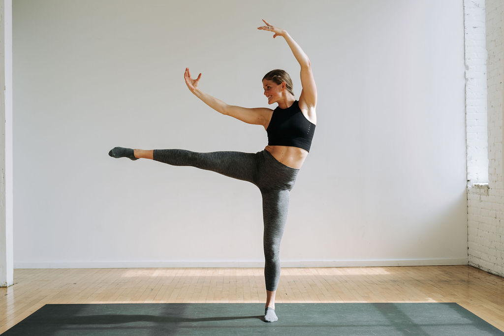 woman performing an arabesque as part of a cardio barre workout