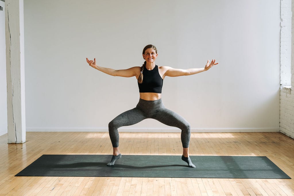 woman finding a second position plie as part of cardio barre workout