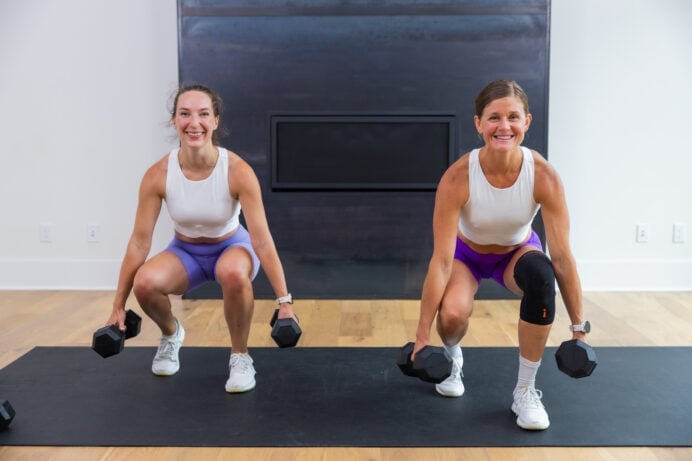 two women performing a staggered squats as example of compound leg exercises