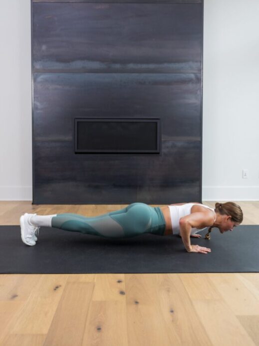 woman holding the bottom of a push up as part of push up training