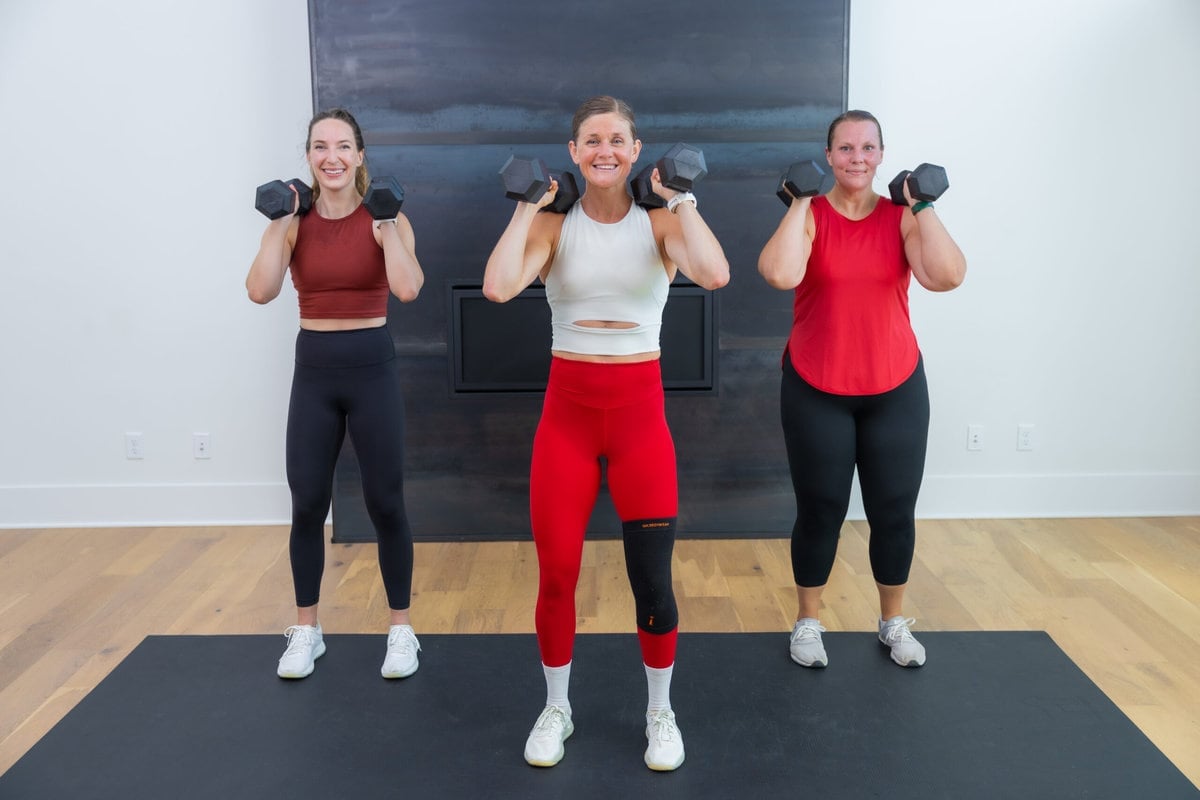 three women performing a shoulder press as part of full body circuit workout