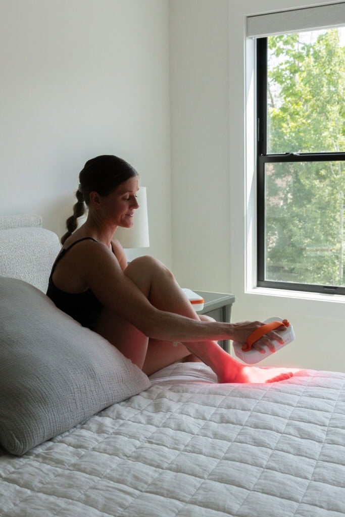Women using a red light therapy lumebox device to help with skin, joints, soreness and recovery.