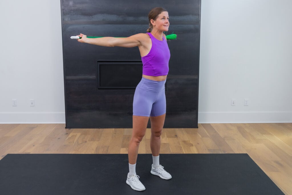 Woman performing shoulder extension as part of shoulder mobility workout