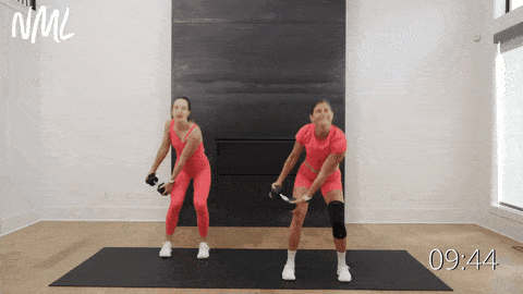 two women performing woodchop exercise as part of oblique workout