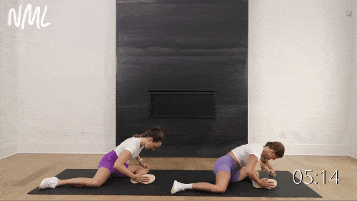 two women performing 90/90 hip stretches as example hip mobility exercises