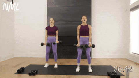 two women performing alternating bicep curls as part of beginner dumbbell workout