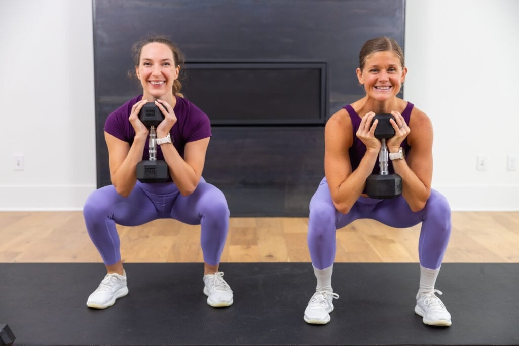 two women performing goblet squats as part of beginner dumbbell workout