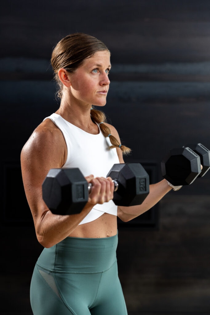 woman holding a bicep curl in an upper body workout