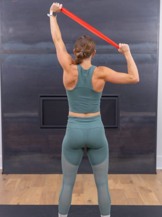 woman performing lat pull down with resistance band