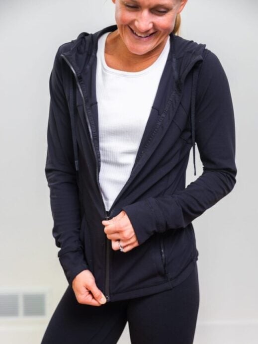 woman zipping up black lululemon define jacket
