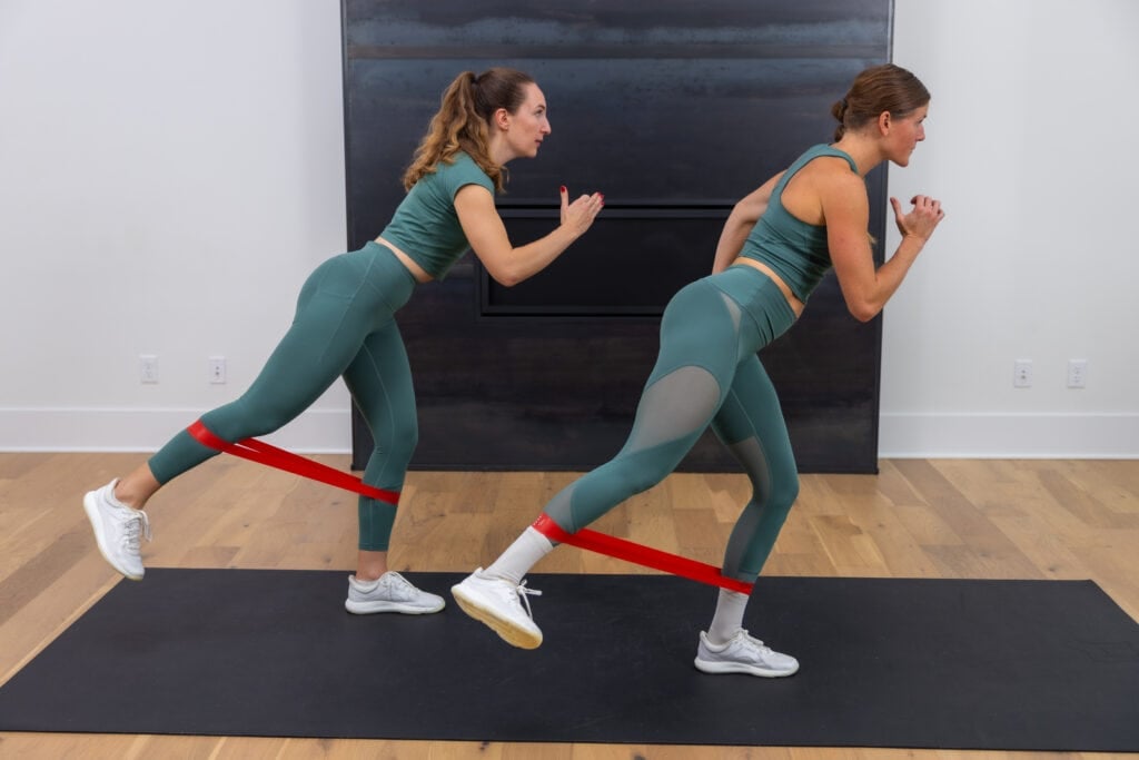 two women performing standing glute kickbacks as example of best exercises with resistance bands