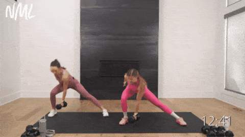 two women performing handswitch lateral lunges as example of full body exercises with dumbbells