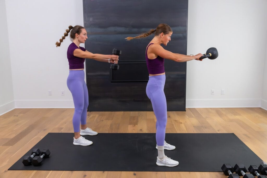 two women performing kettlebell swings in a total body workout at home