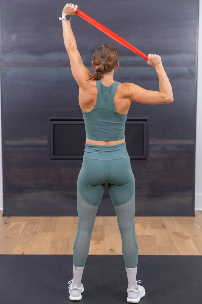 woman performing lat pull down with resistance band