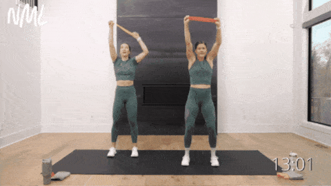 two women performing resistance band lat pull downs