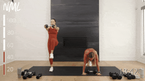 two women performing a plank with an alternating knee drive as part of snatches workout
