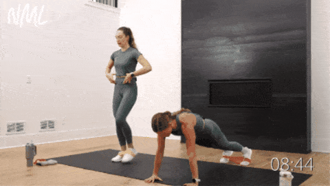 two women performing core exercise with resistance bands