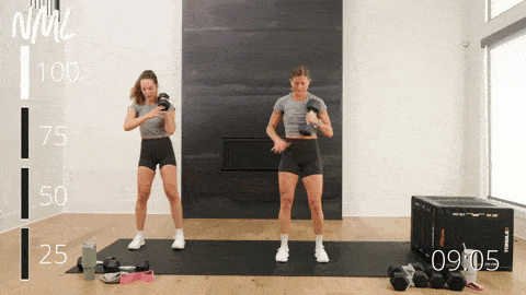 two women performing a dumbbell snatch rack and lateral lunge in a squat workout