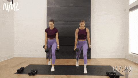 two women performing split lunges as part of beginner dumbbell workout