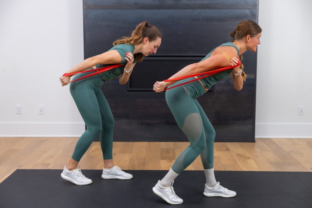 two women performing tricep kickbacks as example of best exercises with resistance bands