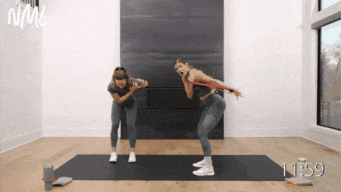 two women performing tricep kickback exercise with resistance band