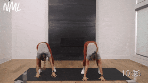 two women performing burpees as part of 15 minute hiit workout