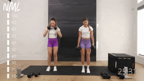 two women performing dumbbell lunges in a leg workout at home