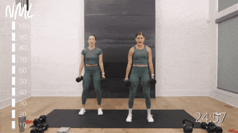two women performing dumbbell squats as part of metabolic conditioning workout