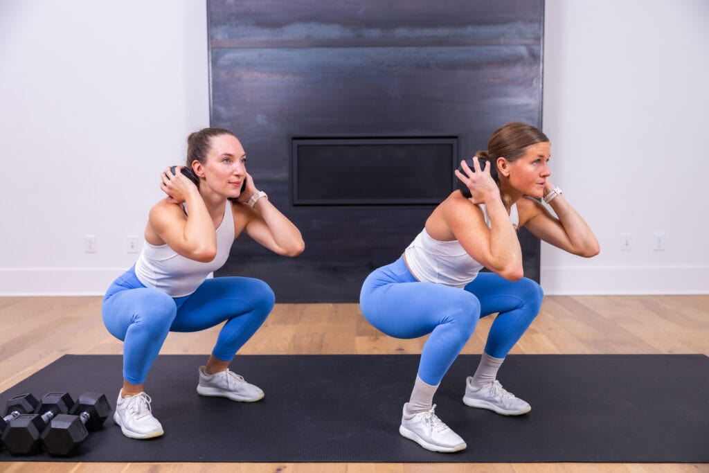 two women performing a kang squat as example of leg exercises at home