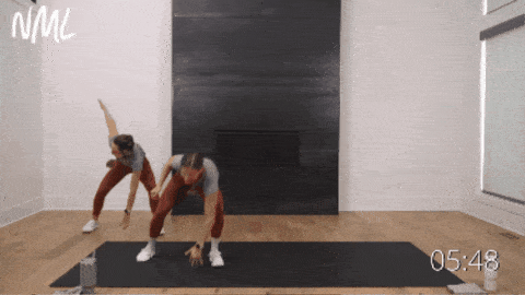two women performing lateral shuffles as part of 15 min hiit workout