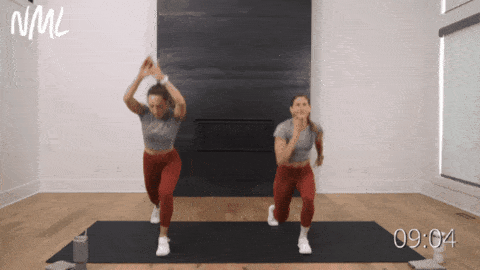 two women performing lunge jumps as part of 15 minute hiit workout
