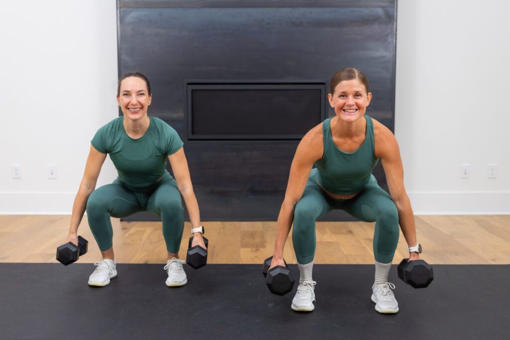 two women performing dumbbell squats as part of metabolic conditioning workout