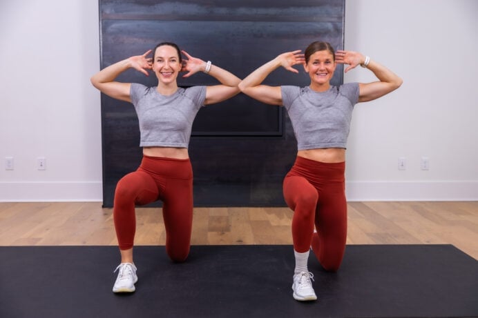 two women performing prisoner get ups as part of 15 minute hiit workout