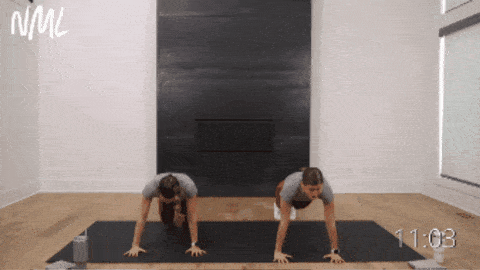 two women performing a push up and knee drive as part of 15 minute hiit workout