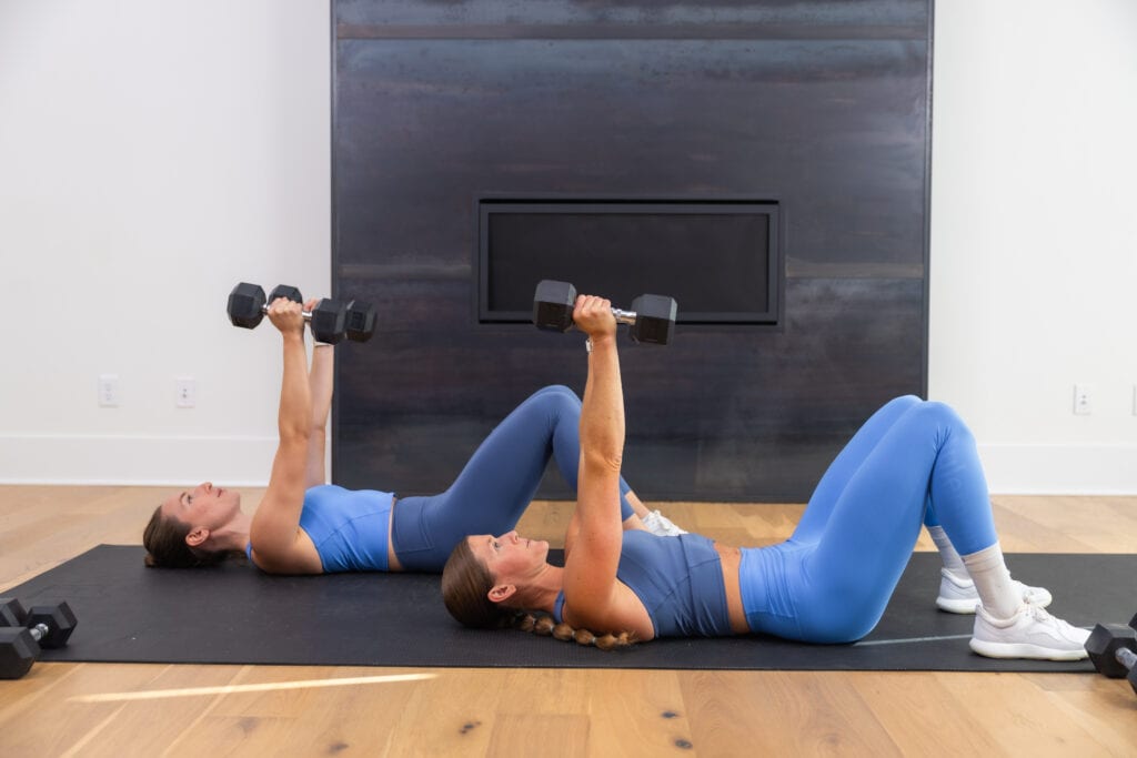 two women performing a narrow chest press as part of back row workout