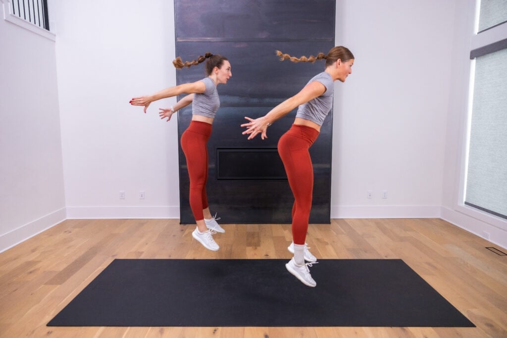 two women performing squat jumps as part of 15 minute hiit workout