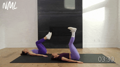 two women performing leg lowers and hip lifts in an ab workout