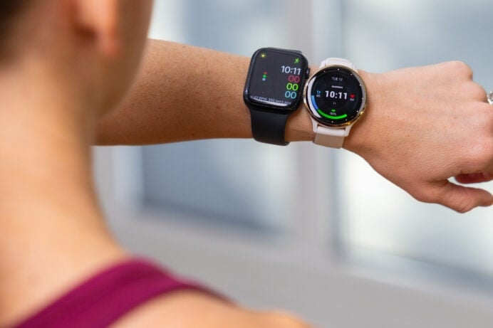 Women wearing black apple watch and white garmin watch on her left wrist.