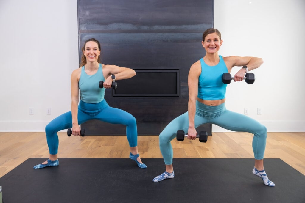 two women performing plie with shoulder raise as example of barre exercises