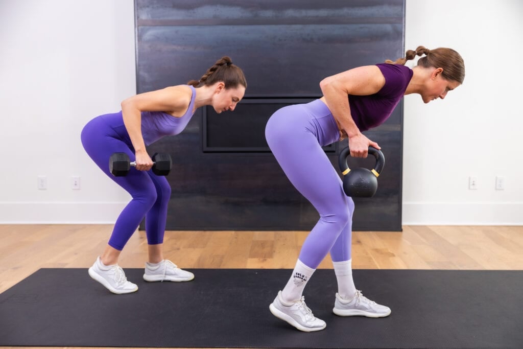 two women performing bent over back rows as part of beginner kettlebell workout