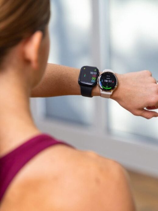 woman wearing both the garmin watch and the apple watch to compare