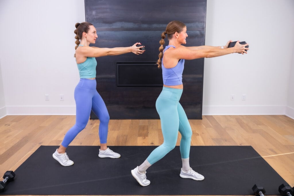two women performing a dumbbell press out as part of upper body dumbbell workout
