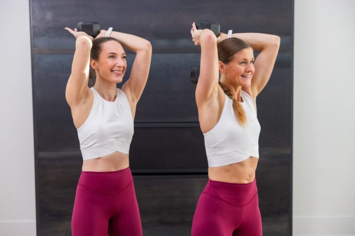 two women performing overhead tricep extensions as part of best dumbbell exercises workout